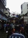 A busy pedestrian street and stairway leading to one of many Hindu temples.